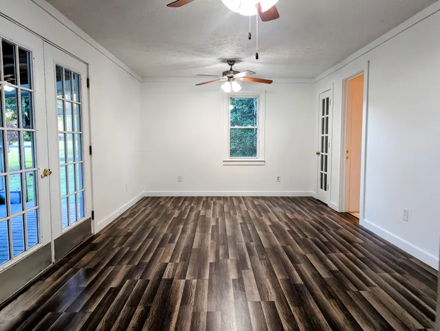 wooden floor in an empty room with a window