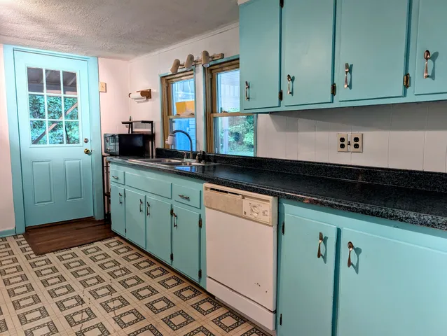 a kitchen with a refrigerator and a stove