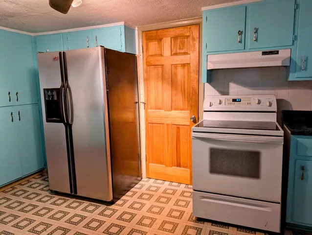 a kitchen with granite countertop cabinets and steel stainless steel appliances
