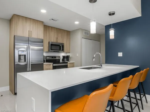 a kitchen with a sink cabinets and refrigerator