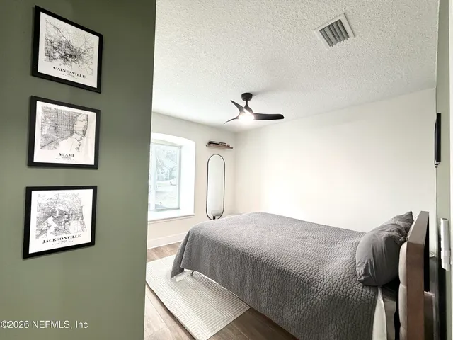 a bedroom with a large bed and a large window