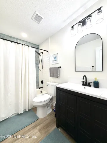 a bathroom with a double vanity sink mirror and toilet