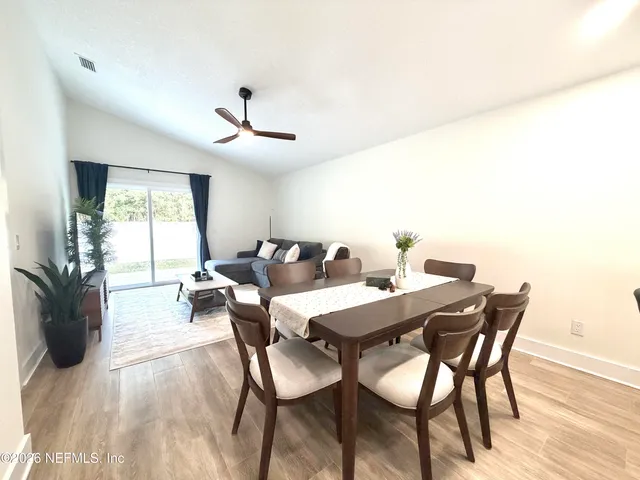 a view of a dining room with furniture and wooden floor