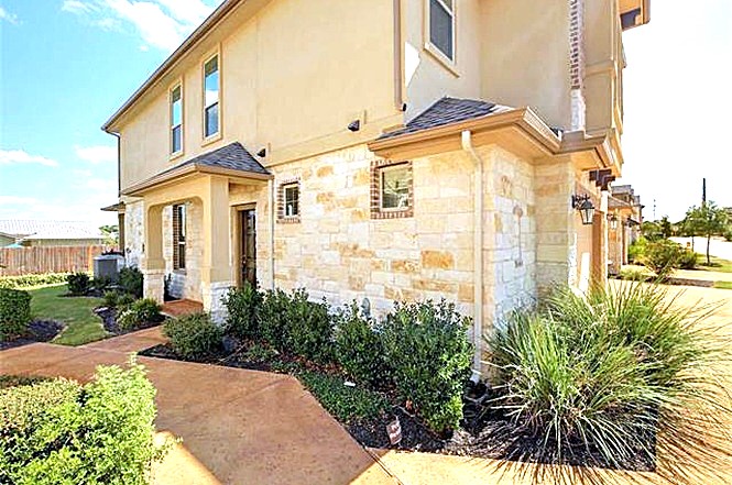 14001 Avery Ranch Boulevard, Unit 801 Austin, TX 78717 - Photo 25 of 26 A well-manicured yard and inviting pathway complement this residence's charming facade.