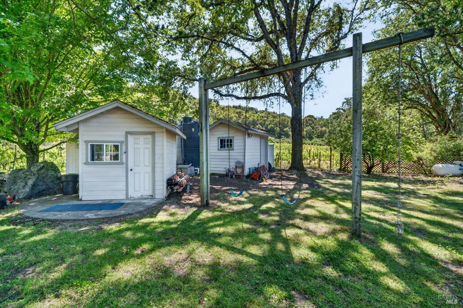 810 McNab Ranch Road Ukiah, CA 95482 - Photo 25 of 32 a backyard of a house with table and chairs and potted plants
