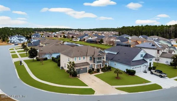 an aerial view of a house with a big yard