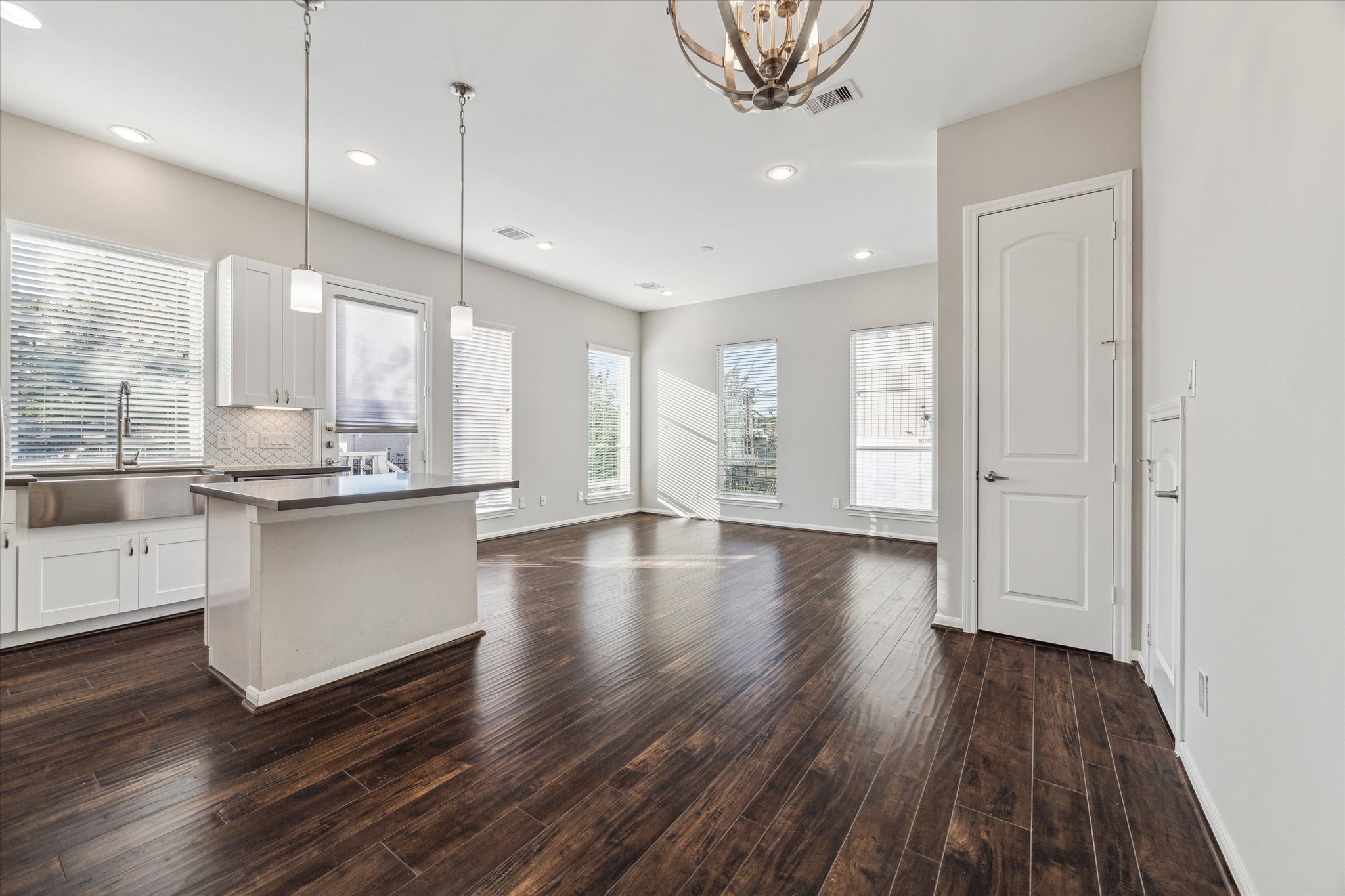 5610 Patrick Street, Unit A Houston, TX 77076 - Photo 3 of 11 a kitchen with stainless steel appliances granite countertop a refrigerator a stove and white cabinets with wooden floor