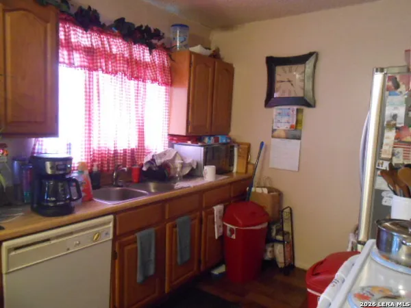 a kitchen with a sink cabinets and window