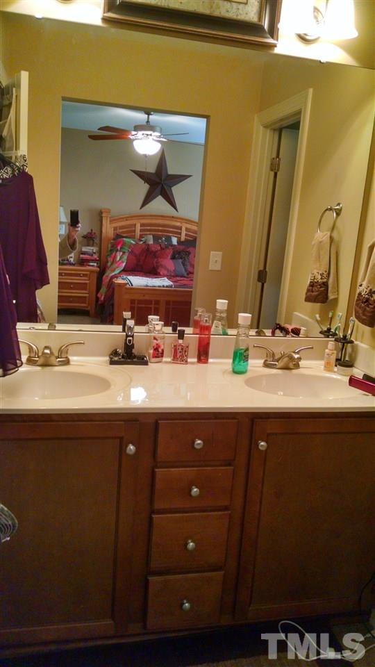 108 Orkney Road Stem, NC 27581 - Photo 13 of 22 a bathroom with a sink and a mirror
