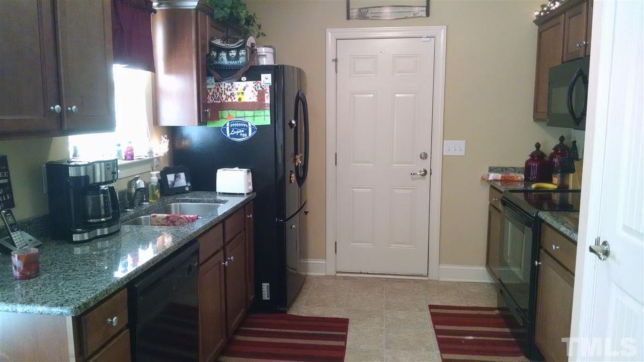 108 Orkney Road Stem, NC 27581 - Photo 15 of 22 a kitchen with granite countertop a sink stove and cabinets