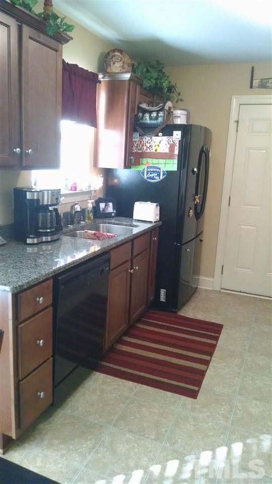 108 Orkney Road Stem, NC 27581 - Photo 16 of 22 a kitchen with a sink and cabinets