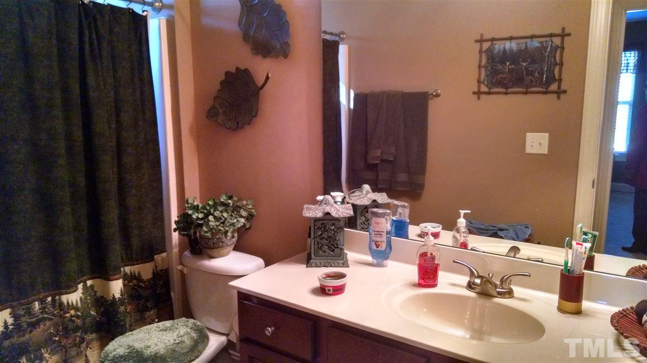 108 Orkney Road Stem, NC 27581 - Photo 10 of 22 a bathroom with a sink and a mirror