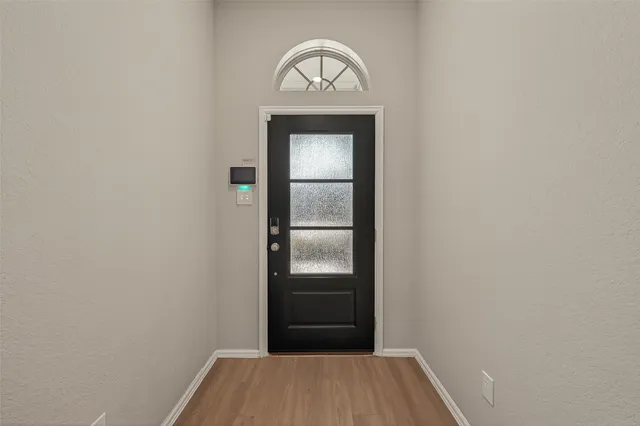 a view of a hallway view with wooden floor