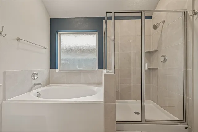 a white bath tub sitting next to a shower