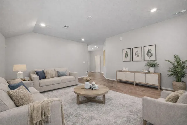 a living room with furniture and white walls