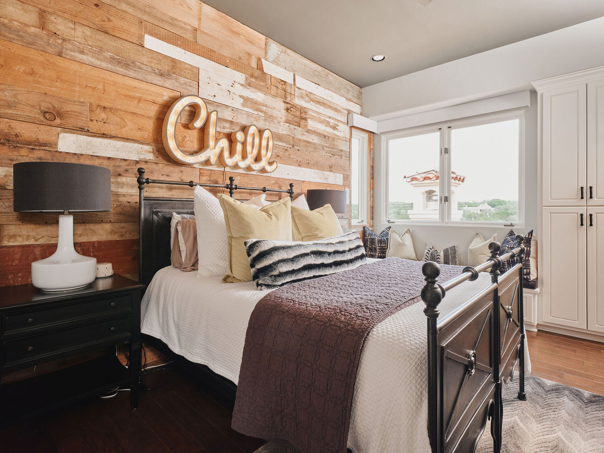 433 Brandon Way Austin, TX 78733 - Photo 33 of 40 A feature wall of reclaimed wood provides a rustic focal point for this restful bedroom.
