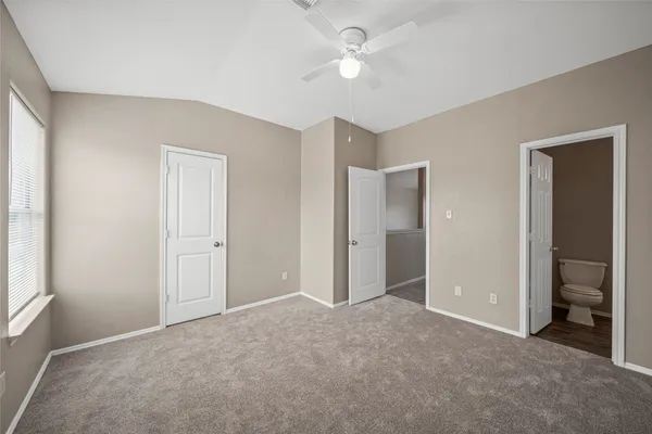 a view of an empty room with a ceiling fan