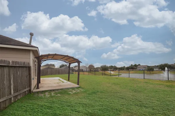 a view of a garden with a car park in the back