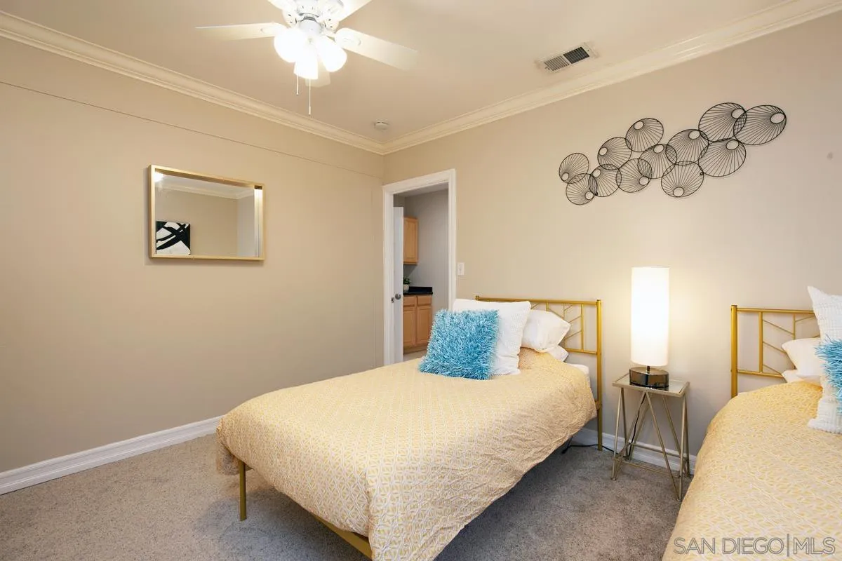 3973 8th Avenue San Diego, CA 92103 - Photo 13 of 21 a bedroom with a large bed and a chandelier