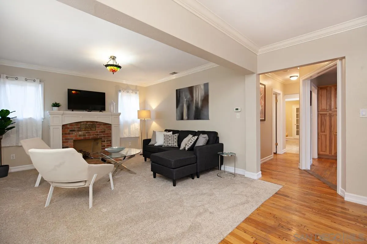 3973 8th Avenue San Diego, CA 92103 - Photo 5 of 21 a living room with furniture a flat screen tv and a fireplace