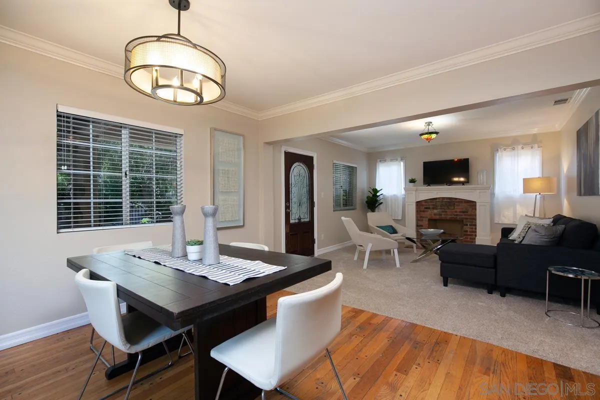 3973 8th Avenue San Diego, CA 92103 - Photo 7 of 21 a living room with furniture a fireplace and a table