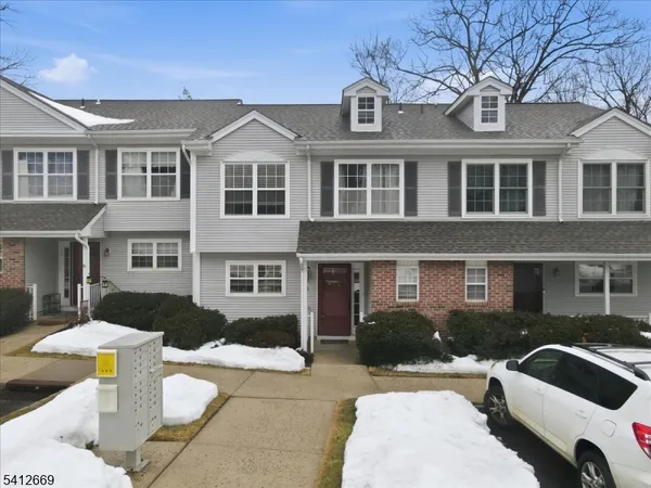 a front view of a house with parking space