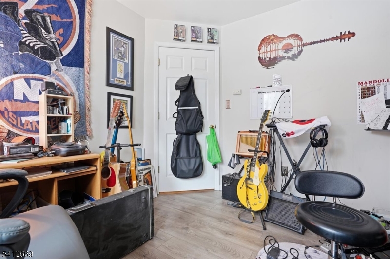 76 Hickory Way Mount Arlington, NJ 07856 - Photo 17 of 25 a room with gym equipment and wooden floor