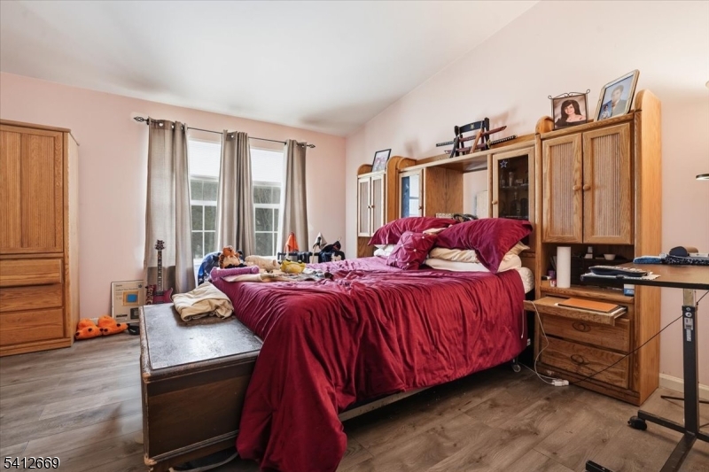 76 Hickory Way Mount Arlington, NJ 07856 - Photo 18 of 25 a bedroom with a bed and wooden floor