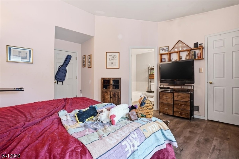 76 Hickory Way Mount Arlington, NJ 07856 - Photo 19 of 25 a bedroom with a bed and a flat screen tv