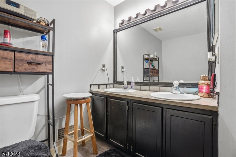 76 Hickory Way Mount Arlington, NJ 07856 - Photo 20 of 25 a bathroom with a sink and a mirror