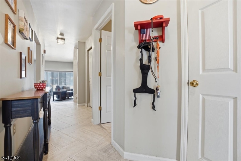 76 Hickory Way Mount Arlington, NJ 07856 - Photo 21 of 25 a view of a hallway with couch and closet
