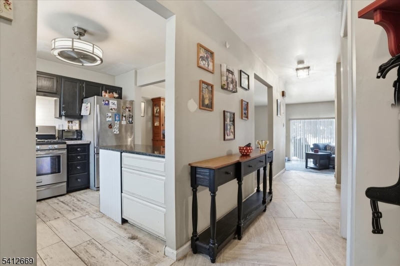 76 Hickory Way Mount Arlington, NJ 07856 - Photo 4 of 25 a kitchen with stainless steel appliances kitchen island granite countertop a refrigerator and a sink