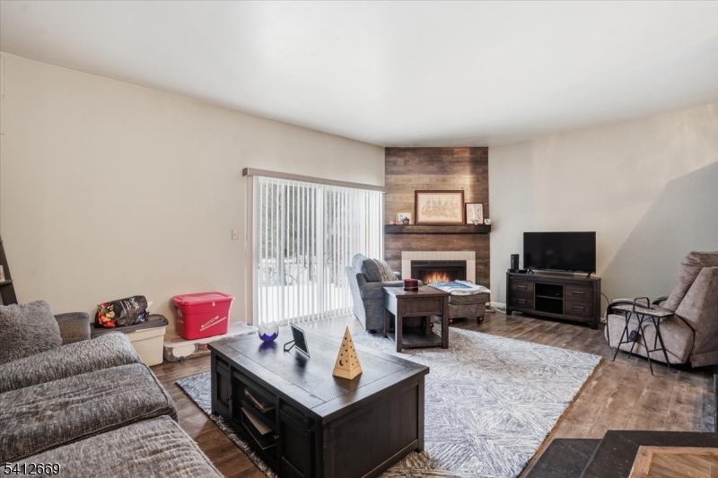 76 Hickory Way Mount Arlington, NJ 07856 - Photo 5 of 25 a living room with furniture a flat screen tv and a fireplace