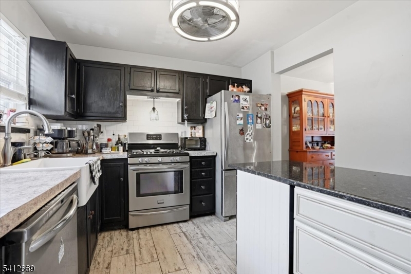 76 Hickory Way Mount Arlington, NJ 07856 - Photo 9 of 25 a kitchen with a refrigerator and a stove top oven