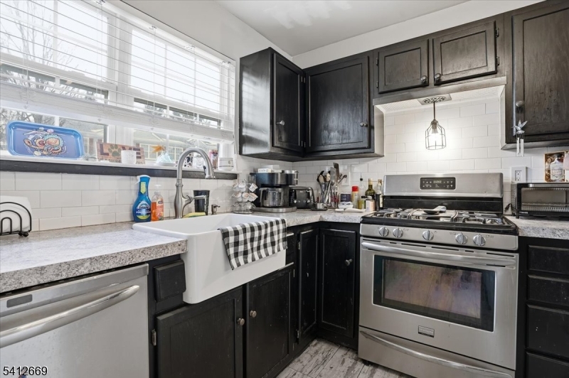 76 Hickory Way Mount Arlington, NJ 07856 - Photo 10 of 25 a kitchen with a stove a sink and a microwave