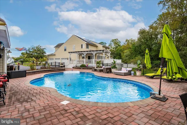 a view of a swimming pool with lounge chair