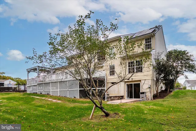 a living room with furniture a fireplace and a chandelier