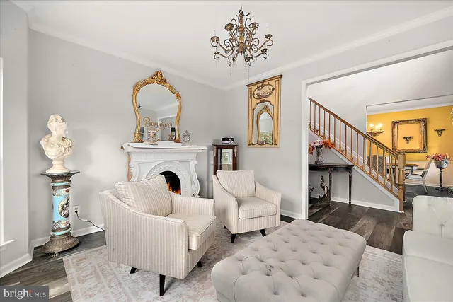 a living room with furniture a fireplace and a large window
