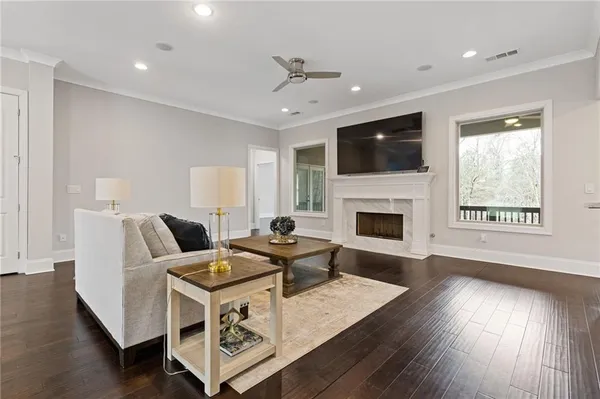 a living room with furniture and wooden floor