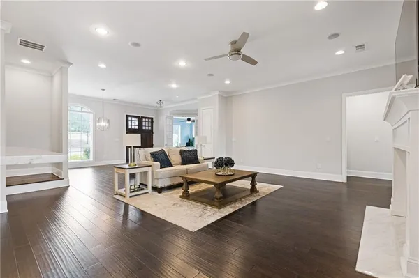 a living room with furniture and wooden floor