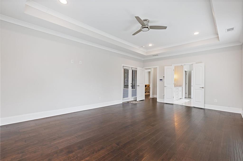 1560 Tapestry Ridge Southeast Lawrenceville, GA 30045 - Photo 16 of 57 a view of an empty room with wooden floor and a ceiling fan