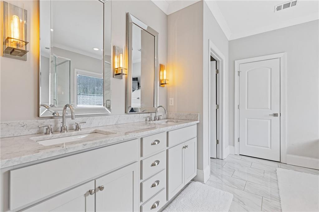 1560 Tapestry Ridge Southeast Lawrenceville, GA 30045 - Photo 17 of 57 a bathroom with a granite countertop sink and a mirror