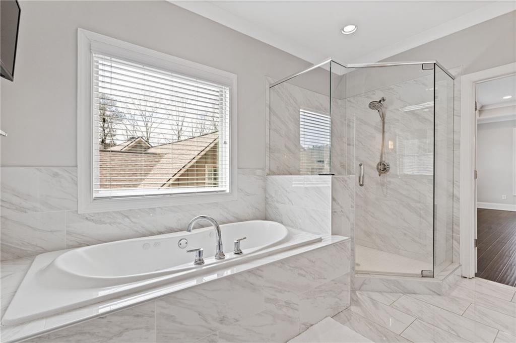 1560 Tapestry Ridge Southeast Lawrenceville, GA 30045 - Photo 18 of 57 a bathroom with a bathtub and shower