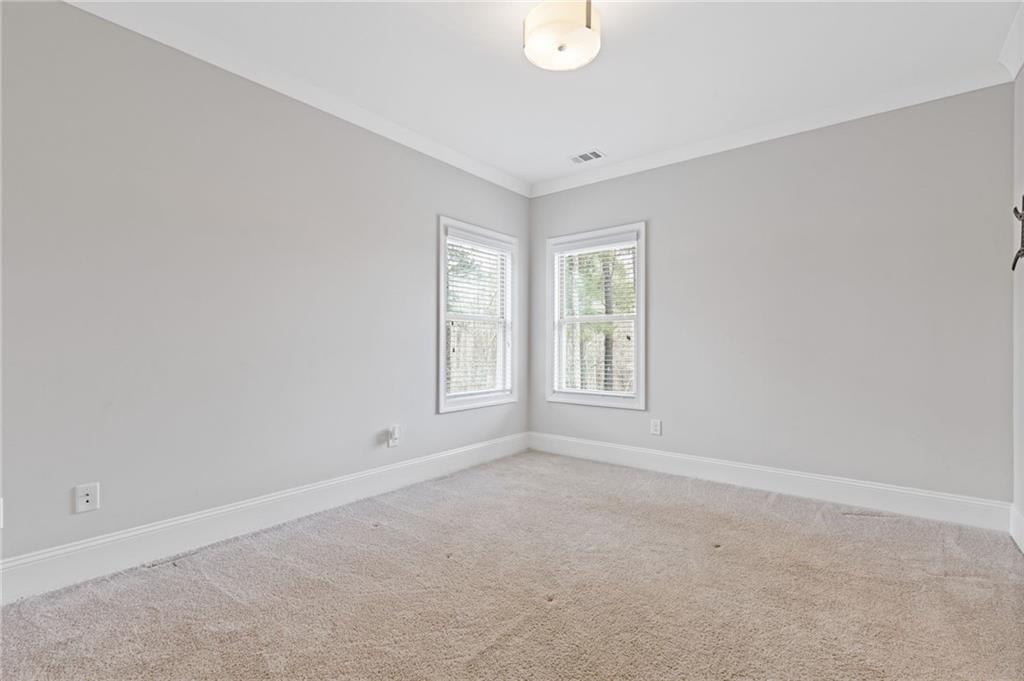 1560 Tapestry Ridge Southeast Lawrenceville, GA 30045 - Photo 21 of 57 an empty room with windows