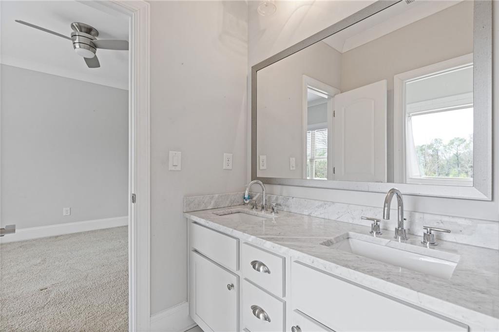 1560 Tapestry Ridge Southeast Lawrenceville, GA 30045 - Photo 23 of 57 a bathroom with a granite countertop sink and a mirror