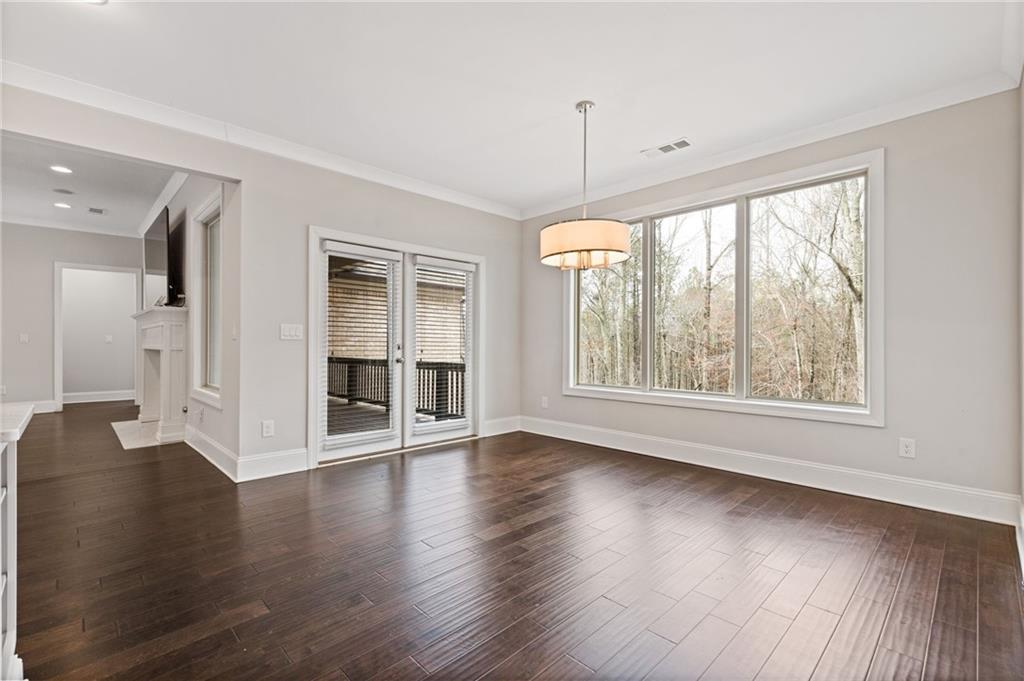 1560 Tapestry Ridge Southeast Lawrenceville, GA 30045 - Photo 27 of 57 a view of an empty room with wooden floor and a window