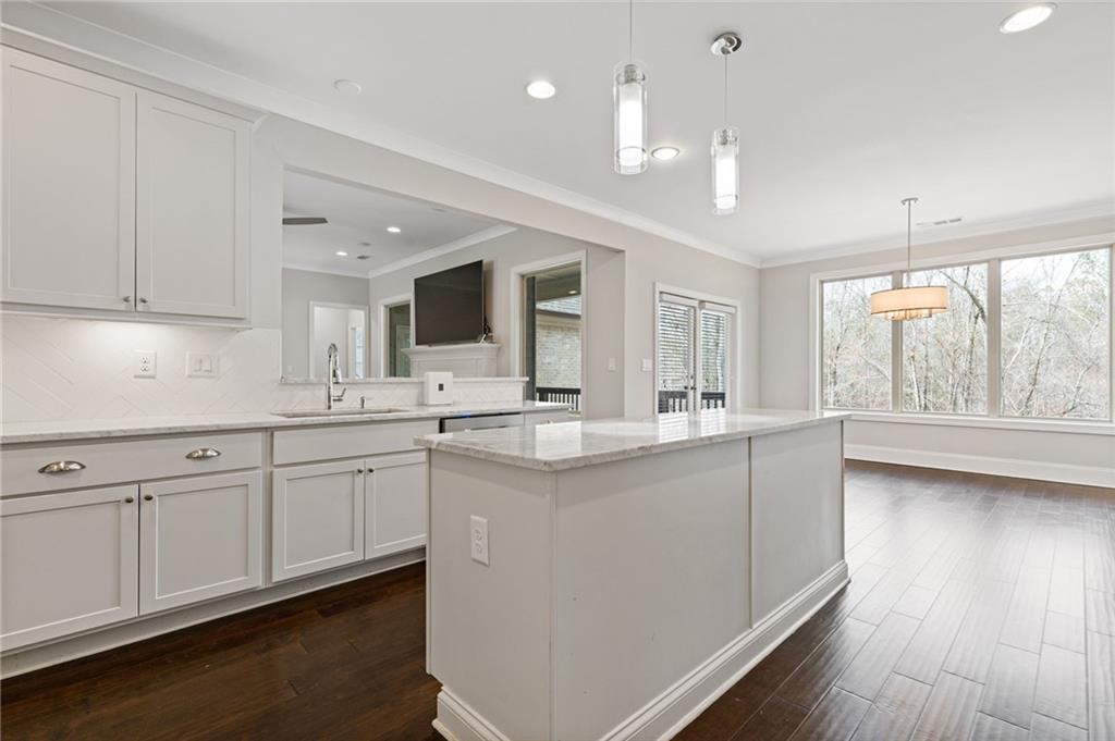 1560 Tapestry Ridge Southeast Lawrenceville, GA 30045 - Photo 32 of 57 a kitchen with center island and windows