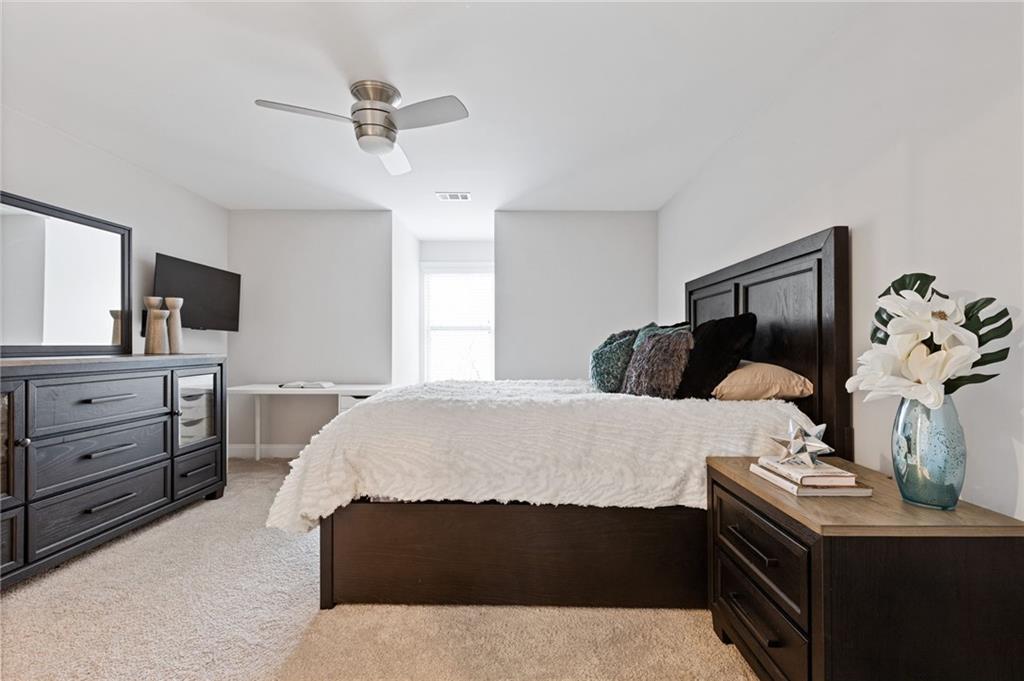 1560 Tapestry Ridge Southeast Lawrenceville, GA 30045 - Photo 37 of 57 a bedroom with a bed and a dresser in it