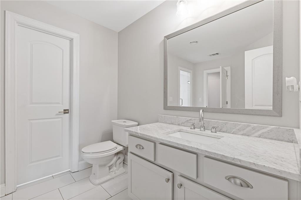 1560 Tapestry Ridge Southeast Lawrenceville, GA 30045 - Photo 39 of 57 a bathroom with a sink a toilet and a mirror