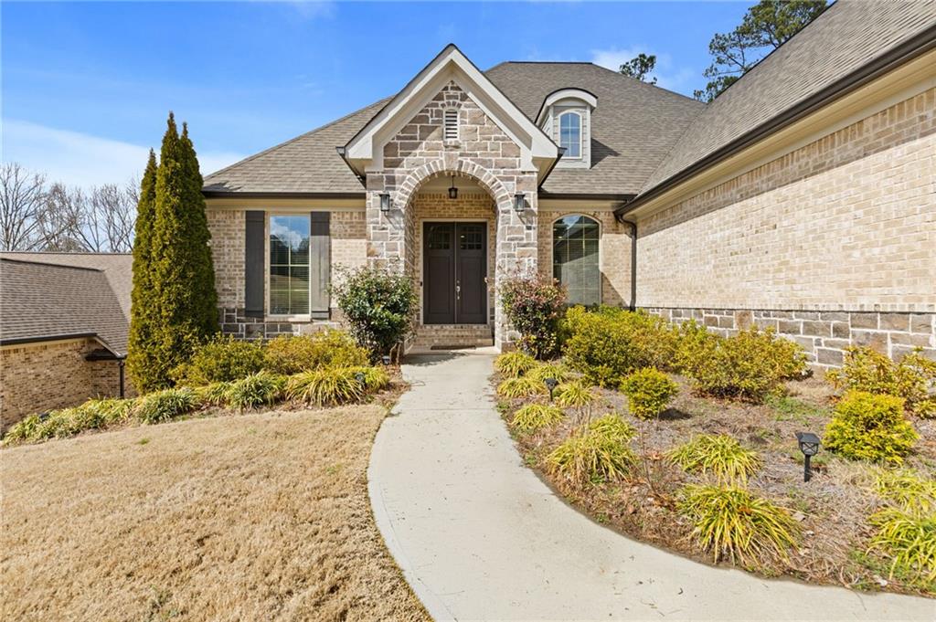 1560 Tapestry Ridge Southeast Lawrenceville, GA 30045 - Photo 4 of 57 a view of a house with large windows and a outdoor space